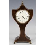 An Edwardian mahogany balloon shaped mantel timepiece, the eight day movement with platform