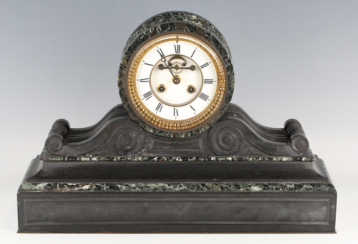 A late 19th century French black slate and marble mantel clock with eight day movement striking on a