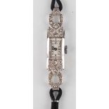 A diamond set lady's dress wristwatch, the jewelled movement detailed 'Swiss Made', the silvered