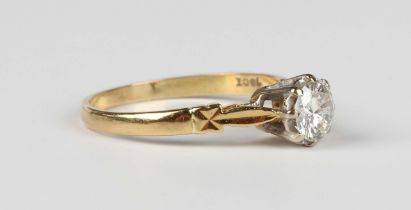 A gold and diamond single stone ring, claw set with a circular cut diamond, detailed '18ct',