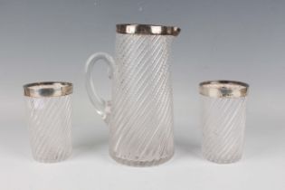 A late Victorian silver mounted spiral moulded glass lemonade jug and two matching beakers, possibly