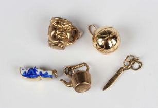 A gold and enamelled charm, designed as a Dutch clog, detailed '585', weight 2.1g, and four 9ct gold