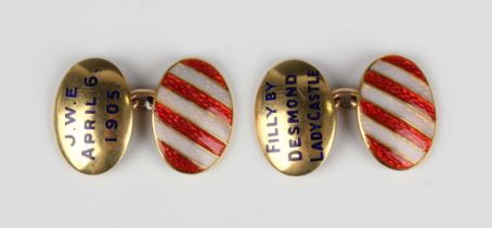 A pair of gold and enamelled dished oval cufflinks, one cufflink detailed 'J.W.E. April 6, 1905',