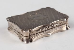 An early Victorian silver vinaigrette of shaped rectangular form with engine turned decoration,