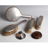 A George V silver four-piece dressing table set with egg and dart borders, comprising hand mirror,