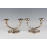 A pair of Norwgian .830 silver twin branch candelabra, each semicircular branch with circular