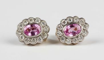 A pair of gold, pink sapphire and diamond oval cluster earstuds, each collet set with an oval cut