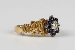 A gold, sapphire and diamond cluster ring, claw set with the circular cut diamond within a