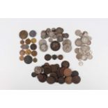 A collection of European and world coins, tokens and medallions, including a group of British and
