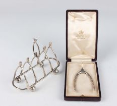 A pair of Edwardian silver wishbone sugar nips, London 1902 by Charles & George Asprey, length 8.