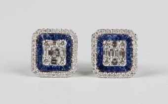 A pair of white gold, sapphire and diamond square cluster earstuds, the centre mounted with baguette