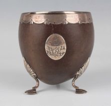 A late 18th century silver mounted coconut cup, the ovoid bowl with scalloped and heart shaped rim