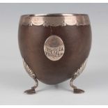 A late 18th century silver mounted coconut cup, the ovoid bowl with scalloped and heart shaped rim