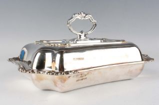 A George V silver shaped rectangular entrée dish, cover and handle, cast with foliate decoration,