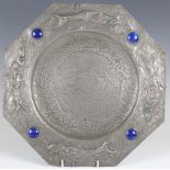 An early 20th century Arts and Crafts style pewter octagonal charger, the raised rim hand-beaten