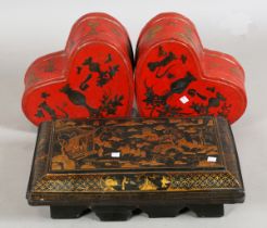 A pair of late 20th century Chinese red lacquered boxes of heart form, width 32cm, together with a