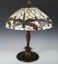 A 20th century bronzed cast metal Tiffany style table lamp with a large stained and leaded glass