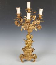 A 19th century French ormolu four-branch candelabrum, modelled with a putto beneath flowers above