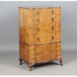 An early 20th century burr walnut serpentine fronted chest of four drawers and cupboard, height