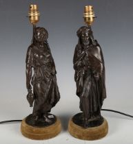 A pair of 20th century brown patinated composite bronze figural table lamps depicting an Eastern