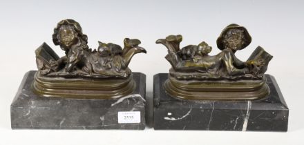 After Auguste Moreau - a pair of 20th century green patinated bronze figures of a young boy and girl