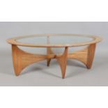 A mid-20th century G-Plan teak oval coffee table with glass top and angular base, height 42cm,