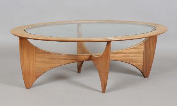 A mid-20th century G-Plan teak oval coffee table with glass top and angular base, height 42cm,