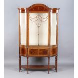 An Edwardian mahogany display cabinet, the arched pediment inlaid with bellflowers above a single