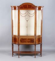 An Edwardian mahogany display cabinet, the arched pediment inlaid with bellflowers above a single