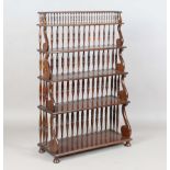 A 20th century Regency style hardwood four-tier waterfall bookcase with turned spindle and lyre