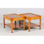 A pair of late 20th century Bevan Funnell 'Reprodux' yew two-tier lamp tables, each fitted with a