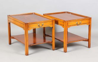 A pair of late 20th century Bevan Funnell 'Reprodux' yew two-tier lamp tables, each fitted with a