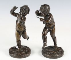 A pair of late 19th century French brown patinated cast bronze cherubs, each raised on a