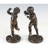 A pair of late 19th century French brown patinated cast bronze cherubs, each raised on a