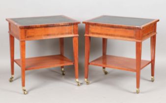 A pair of late 20th century reproduction walnut leather-topped lamp tables with gilt brass caps