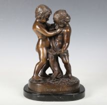 A modern brown patinated cast bronze model of two putti on a naturalistic base and black marble