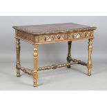 A late Victorian walnut and gilt decorated writing table, fitted with two frieze drawers with carved
