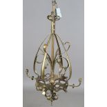 A large Arts and Crafts brass hanging ceiling light, in the manner of W.A.S. Benson, the central