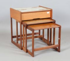 A mid-20th century G-Plan teak nest of three occasional tables, the top table fitted with a tiled