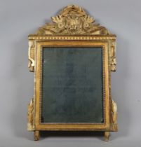 A late 18th century French giltwood wall mirror with laurel leaf and scroll surmount above a