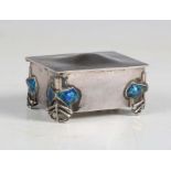 An Edwardian Arts and Crafts silver and enamelled trinket box by Liberty & Co, the domed lid above