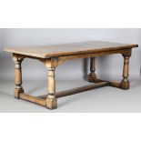 A 20th century Jacobean Revival solid oak refectory table, raised on turned and block legs, height