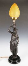 A late 19th/early 20th century patinated spelter figural table lamp, modelled as a Grecian female