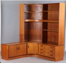 A mid-20th century G-Plan teak wall unit with curved central section above cupboards, height