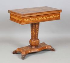A 20th century Killarney style inlaid walnut fold-over games table, the lid and interior decorated