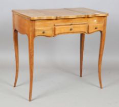 A 20th century French walnut poudreuse dressing table, fitted with three hinged lids above two