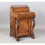 A mid-Victorian burr walnut piano-top Davenport, the pop-up stationery compartment above a curved