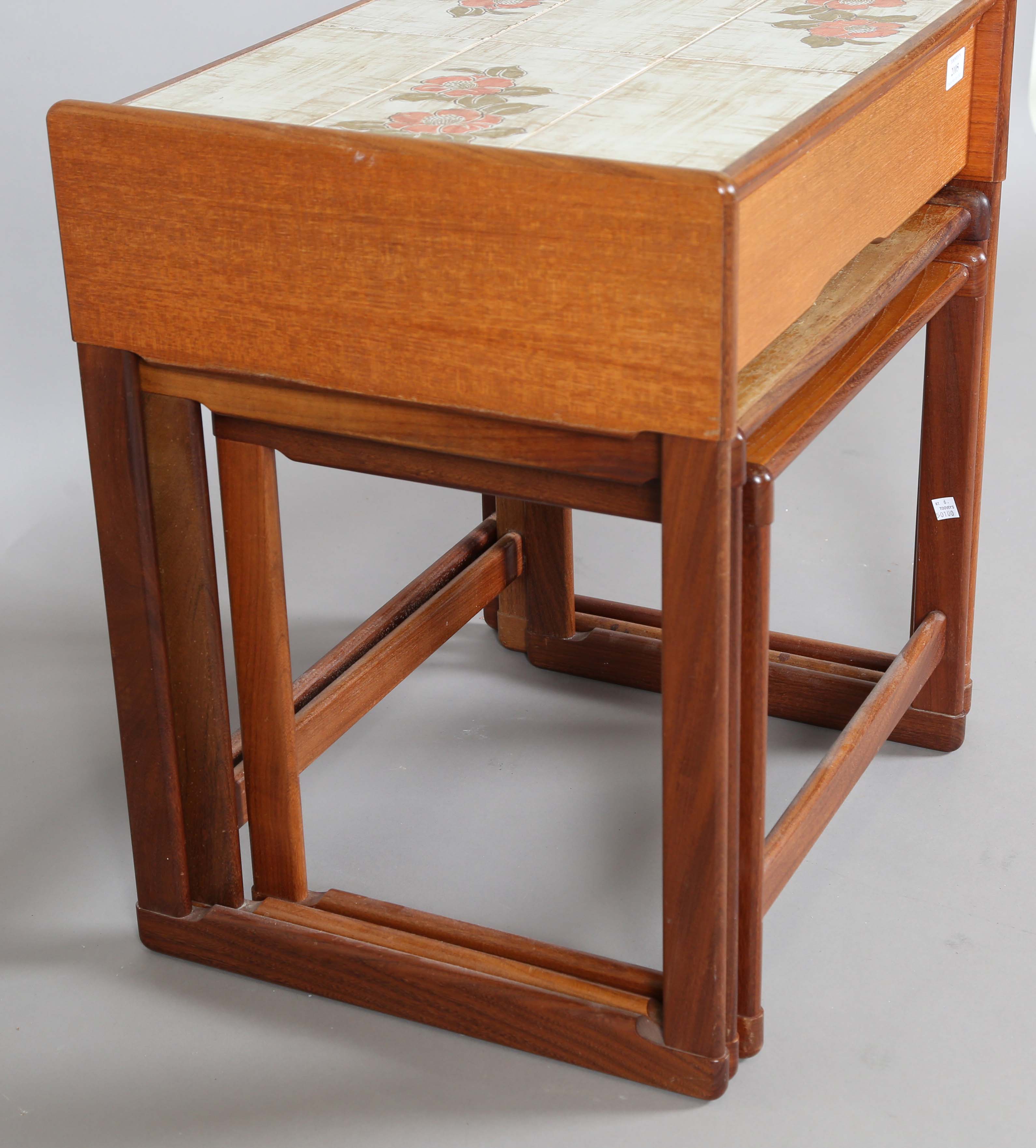 A mid-20th century G-Plan teak nest of three occasional tables, the top table fitted with a tiled - Image 3 of 6