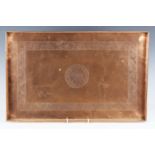 An early 20th century Arts and Crafts copper rectangular tray, engraved with central medallion and