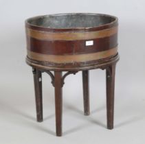 A George III mahogany oval coopered wine cooler, raised on an associated stand, height 58cm, width